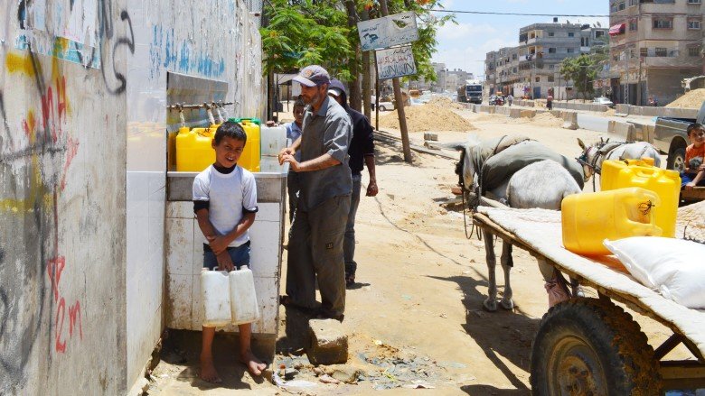 kid holding two water cane