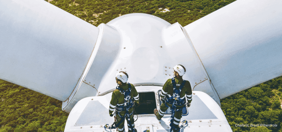 two man standing on the wind mill