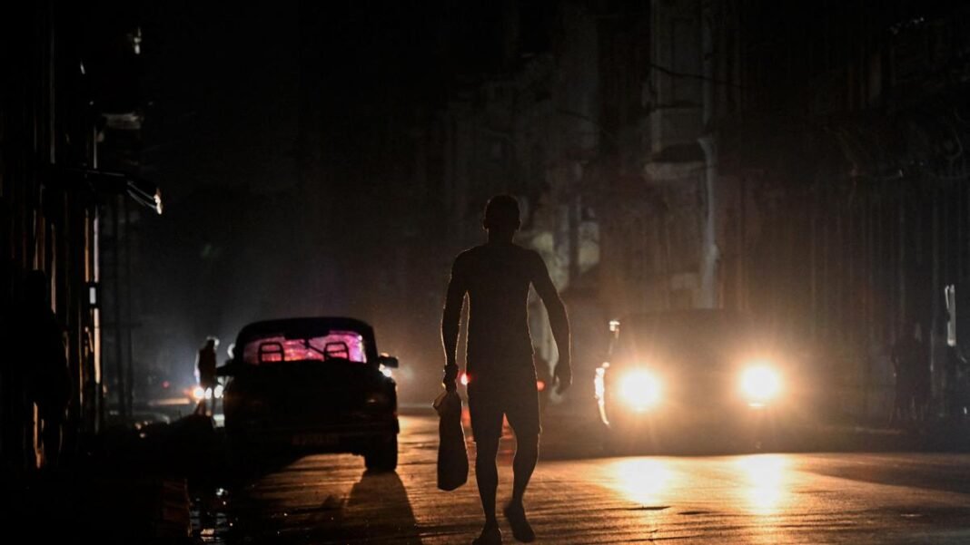 man walking on the road at night
