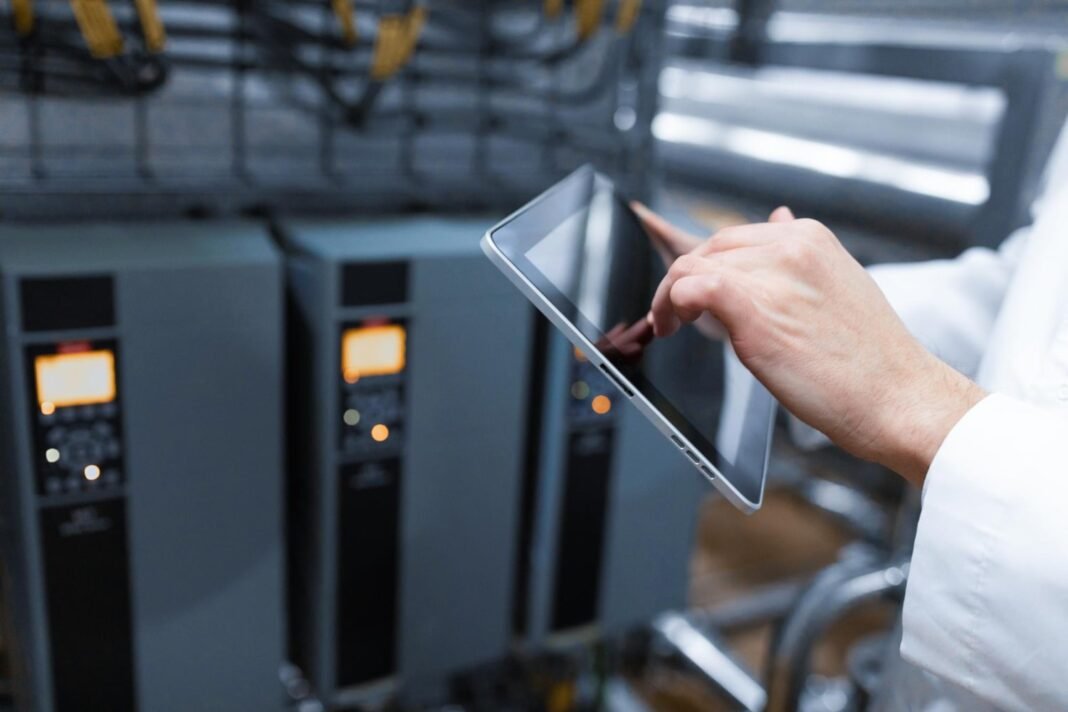image about Technologist with grey tablet in his hands make a set up of the production line