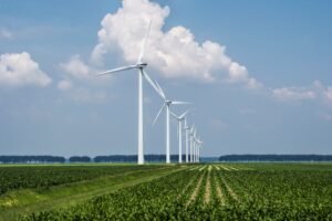 image about Beautiful view of the wind turbines on a grass covered field captured in Holland